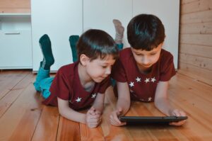 Siblings playing games on tablet